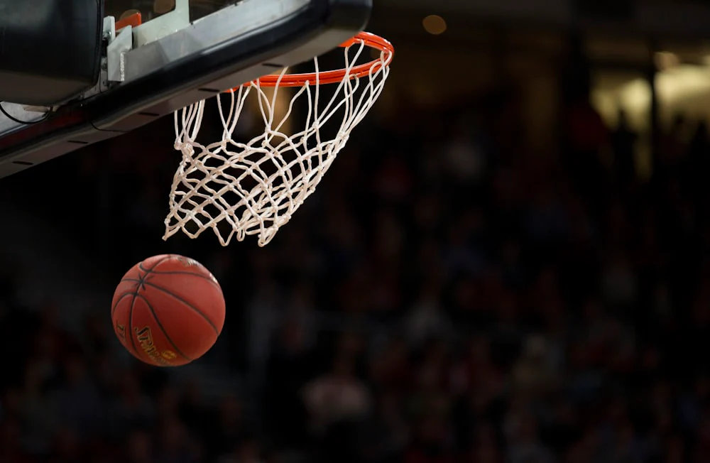 Close-up of a basketball dropping out of a hoop during a made shot